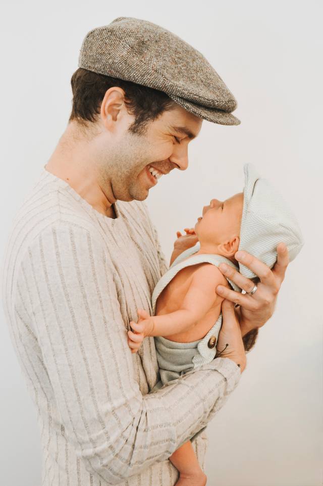 Richard Ludlow holding his infant son